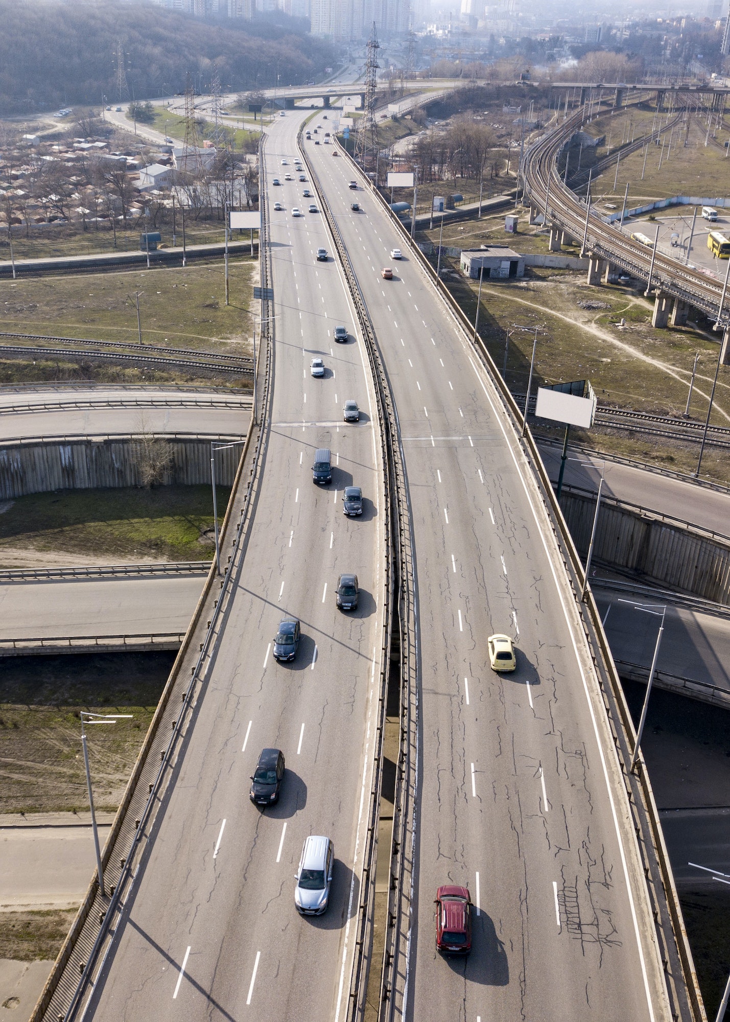 Aerial view from drone traffic overpass with moving cars on an asphalt road in a sunny day Kiev